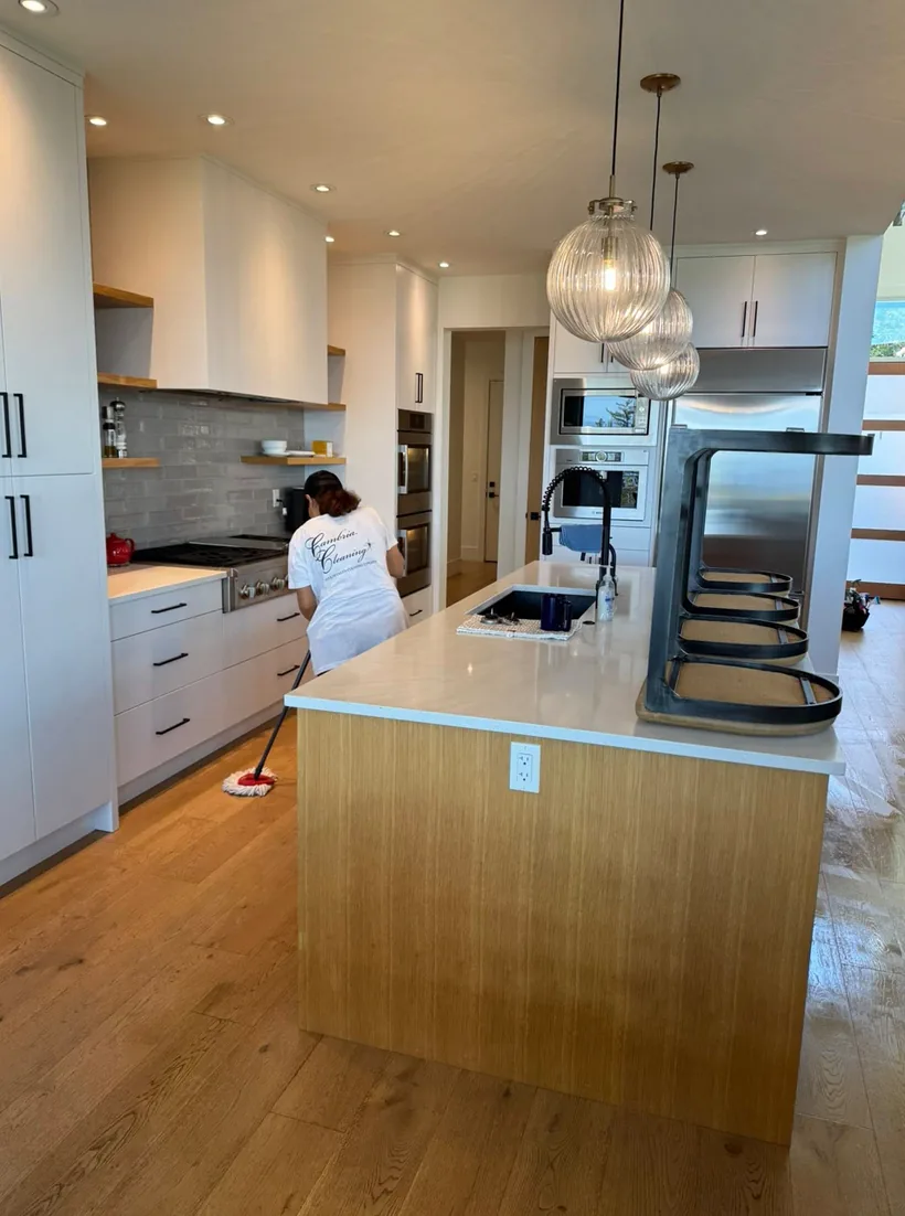 A Cambria Cleaning team member cleaning a kitchen