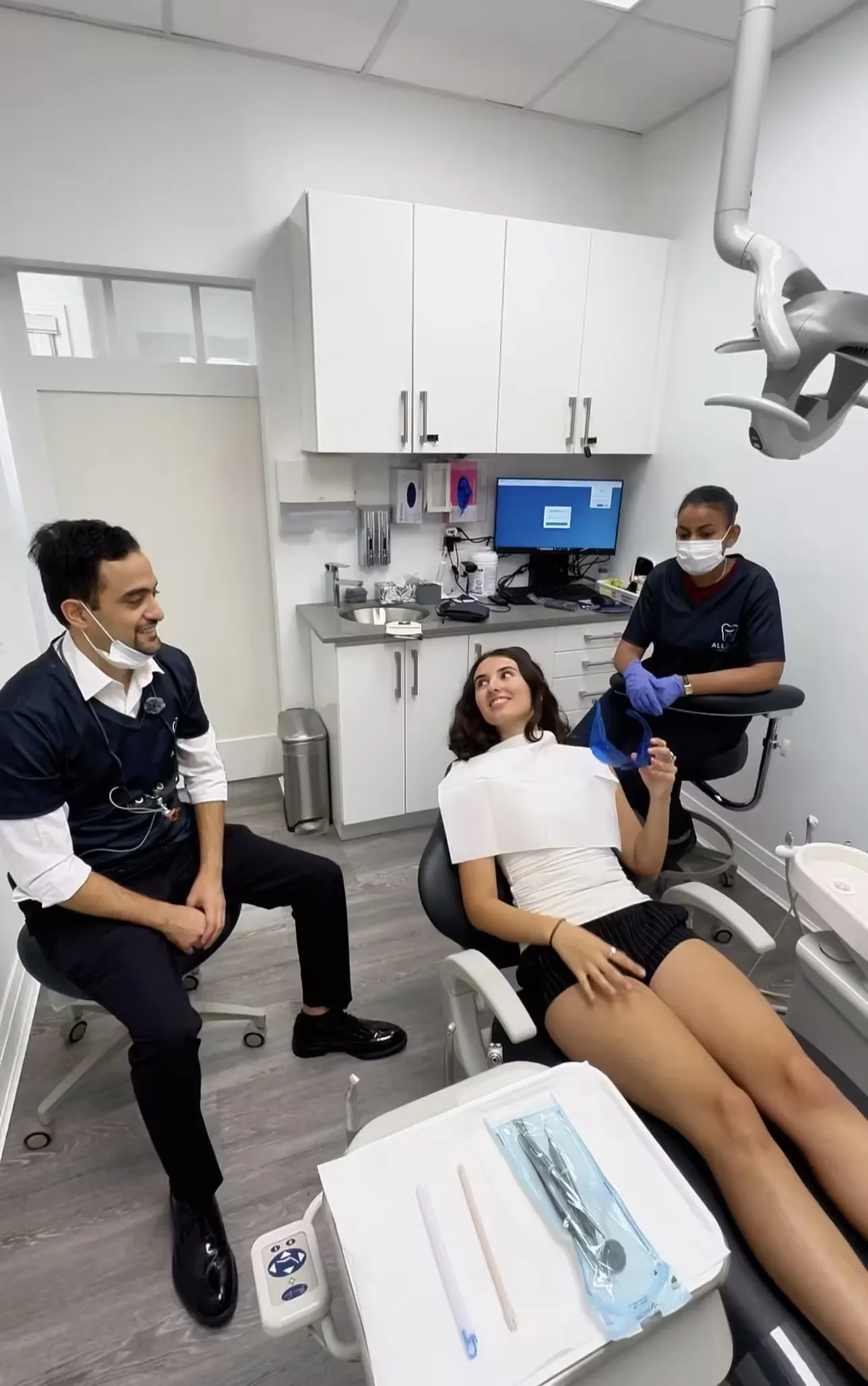 Inside a dental clinic, dentist and patient talking