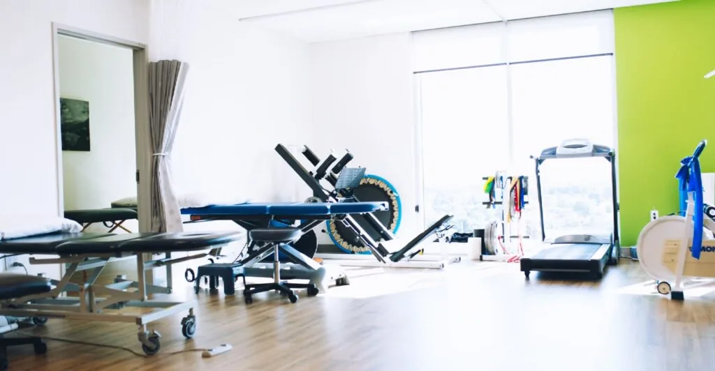 Treatment tables and rehab equipment inside a physiotherapy clinic