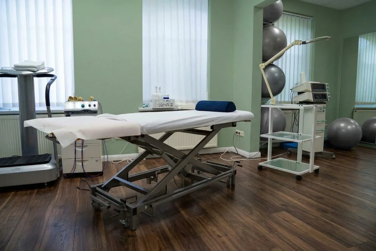 A treatment table and exercise equipment in a physiotherapy room