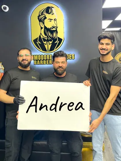 Andi holding up a sign with a customer's name on it
