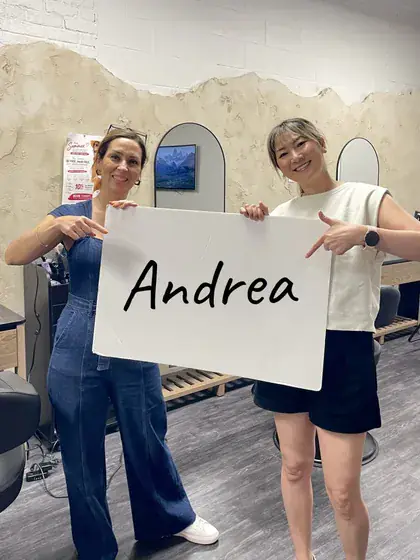 Anita holding up a sign with a customer's name on it