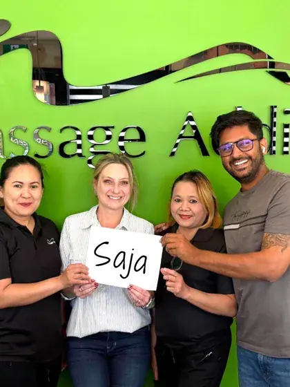 Massage Addict holding up a sign with a customer's name on it